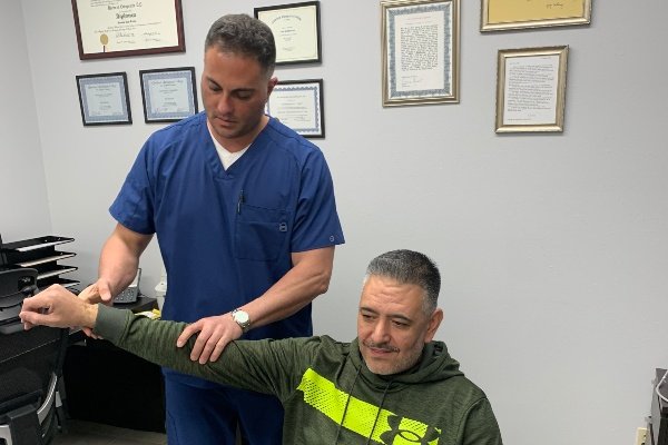 Doctor performing functional capacity test with patient's right arm